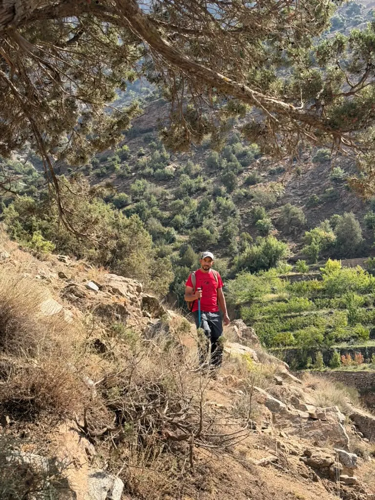 Khalid on a mountain slope with terraced fields below