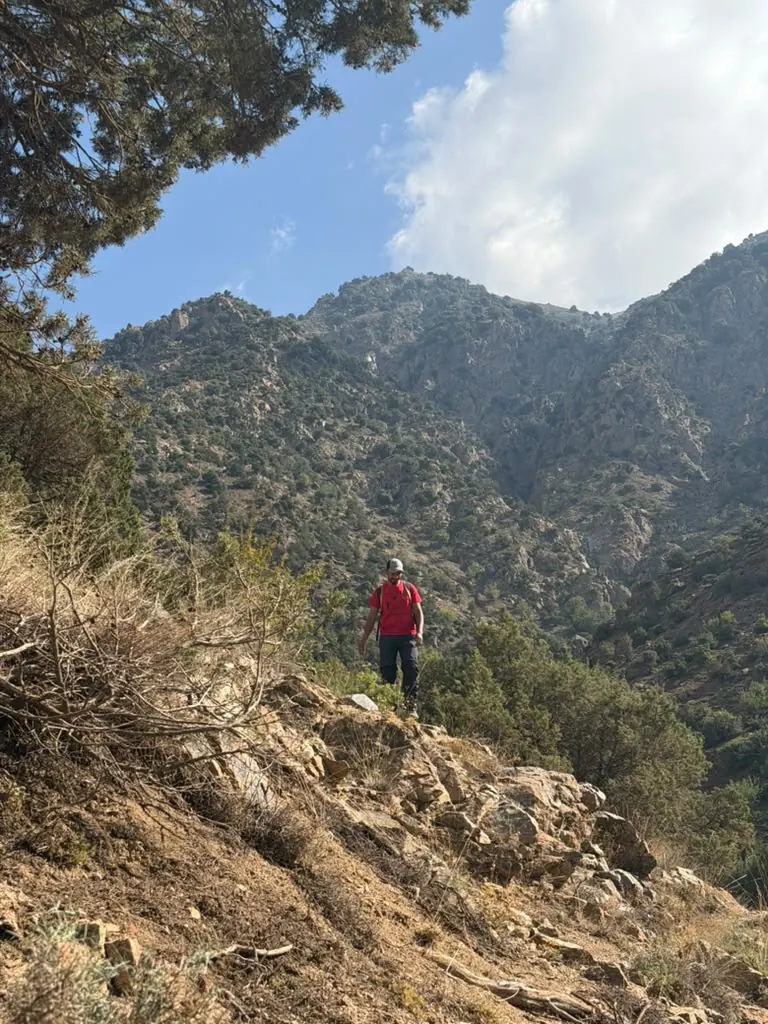 Khalid as a tiny figure on a huge mountain slope