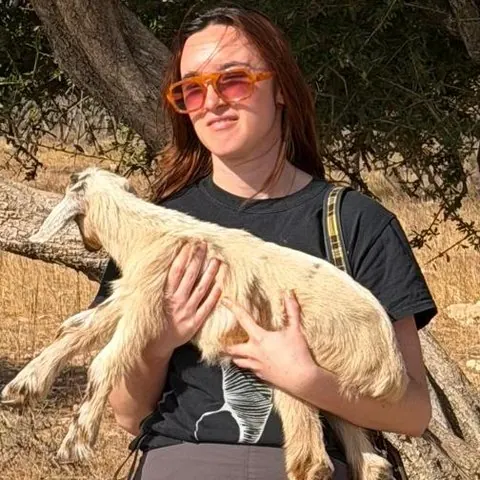 Sterre, a guest who hiked with Khalid, holding a baby goat
